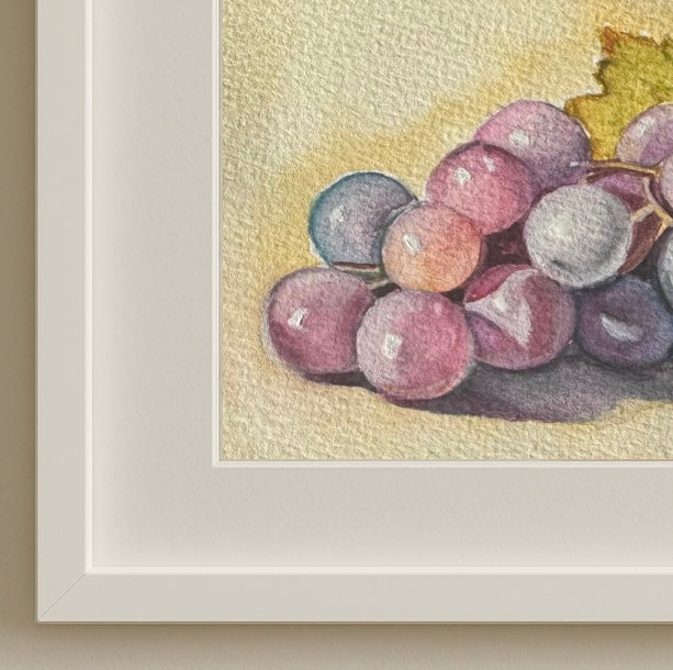 Minimalist wooden frame surrounding “Grapes in Light,” a framed original watercolour painting by Shanaz Minhas.